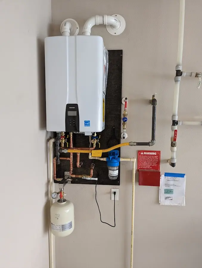 Professional plumber installing copper piping in a Archer Lodge home